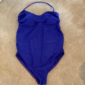 Motherhood maternity swimsuit with ruffle detail at bust and ruching on sides.